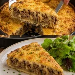 Verse Zwiebelkuchen met uien en spek, geserveerd op een bord.